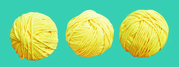 Pastel yellow ball of wool isolated with clipping path, no shadow in green background