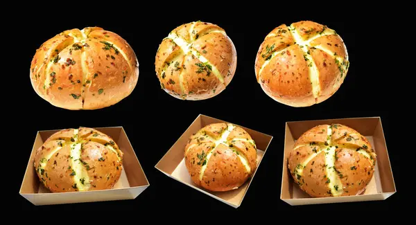 Korean cream cheese garlic bread in Kraft box food isolated with clipping path, no shadow in black background, bakery pastry bread