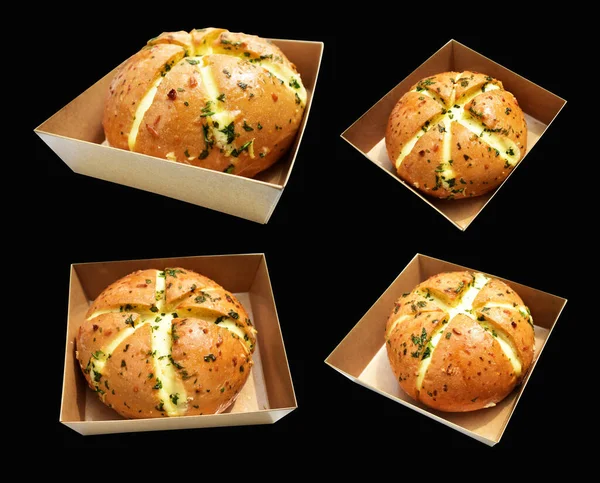 Korean cream cheese garlic bread in Kraft box food isolated with clipping path, no shadow in black background, bakery pastry bread