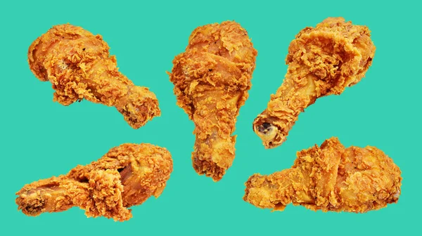 Crispy fried chicken leg drumstick isolated with clipping path, no shadow in green background, fast food