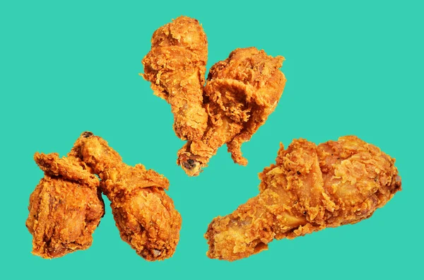 Crispy fried chicken leg drumstick isolated with clipping path, no shadow in green background, fast food