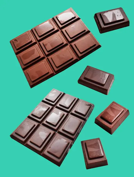 Milk chocolate pieces isolated with clipping path, no shadow in green background, cooking ingredient, homemade sweet dessert