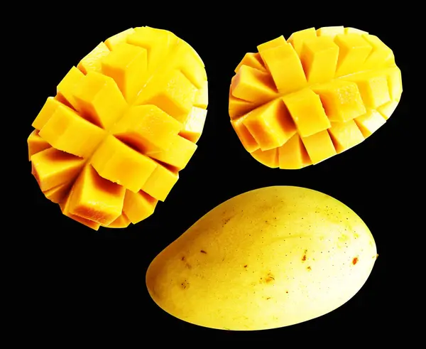 Mango slice cube isolated  with clipping path, no shadow in black background, mango cut to cube pieces, healthy tropical fruit