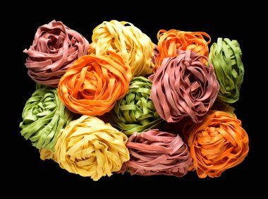 Renkli İtalyan tagliatelle veya Fettuccine makarnası klasik istif, yuva yumurtası İtalyan makarnası kırpma yolu izole, siyah arka planda gölge yok, yemek malzemesi yok