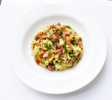 Beyaz arka planda kızarmış pirinç. Çin pilavı, karışık sebze, yumurta ve sosis (Yangzhou tarzı).)