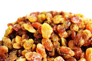 Beyaz arka planda izole edilmiş sarı ve kahverengi kuru üzüm yığınları. Güneşli ve parlak.