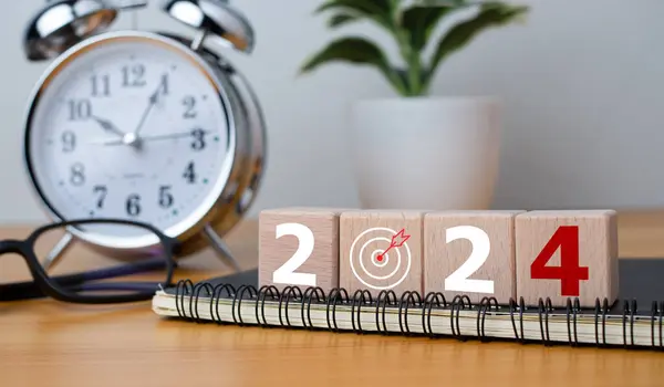 Wooden blocks with letters 2024 with calendar and alarm clock on wooden background representing the transition to 2024, Business Startup plan, The countdown begins to 2024, defining the future calendar strategy.