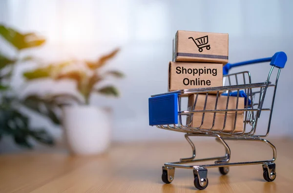 Online shopping, Product package boxes in cart with shopping bag  delivery concept, Shopping service on The online web and offers home delivery, online shopping and delivery concept.