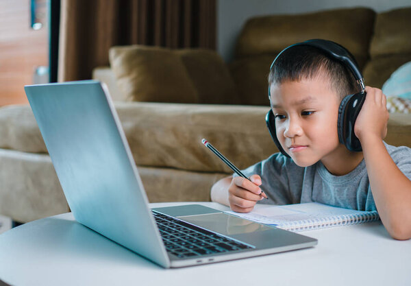 Online education, Technology studying at home using laptop computer, Student distance learning virtual distance online class on video call virtual lesson, Teaching child boy with remote education.