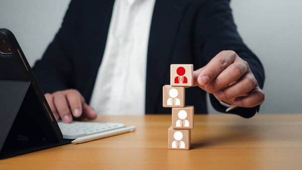 Business recruiter with one person shown with wooden cubes with icons, Recruitment employee and talent management with Successful business team leader concept, Personal auditing or CRM concept.