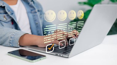 Customer feedback survey concept with satisfaction rating icons on laptop. Online review, UX, user experience, business evaluation, and digital rating system.
