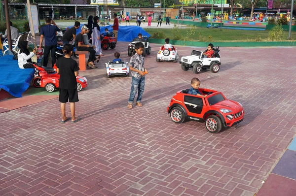 stock image Sangatta, East Kalimantan, Indonesia. February 15,2020. Children driving Electric Battery Operated Toy at city park beside playground. Electric toy cars for kids to rent.                                                            