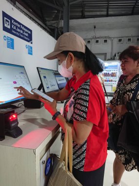 photo editorial, 07 november, 2 women doing ticket printing at yogyakarta  yogya, jogja, jogjakarta, indonesia train station