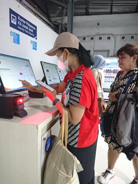 photo editorial, 07 november, 2 women doing ticket printing at yogyakarta  yogya, jogja, jogjakarta, indonesia train station