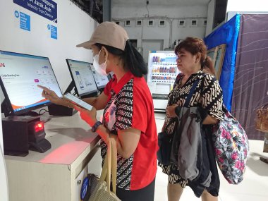 photo editorial, 07 november, 2 women doing ticket printing at yogyakarta  yogya, jogja, jogjakarta, indonesia train station