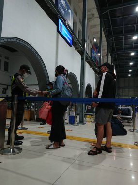 photo editorial, 07 november, queueing people for ticket checking by security, indonesia