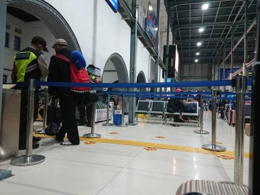 photo editorial, 07 november, queueing people for ticket checking by security, indonesia