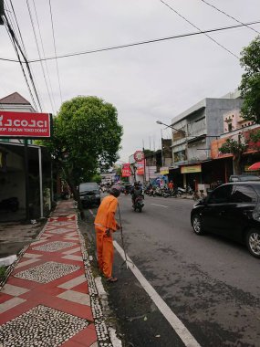 photo editorial, 29 december 2022, indonesia, using crutches walking old parking officer at side walk