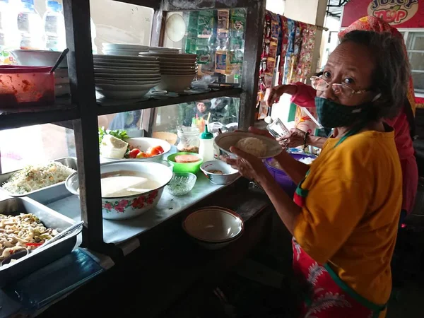 photo editorial, 29 december 2022, indonesia buyer and seller traditional food small restaurant, ngasem market, yogyakarta, indonesia