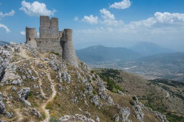 The ancient castle of Rocca Calascio where the film Ladyhawke was filmed with the beautiful mountains and hills of Abruzzo in the background clipart