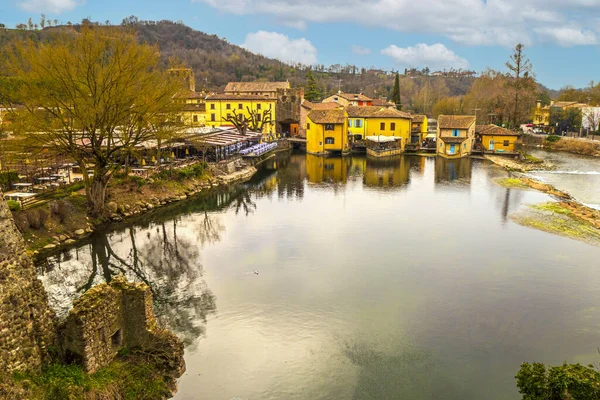 stock image Valeggio, Italy - 03-02-2022: High angle view of borghetto sul Mincio with the buildings reflecting on the water