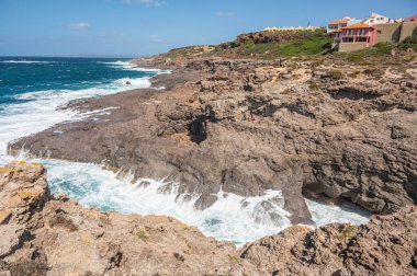 The beautiful Cala Grotta in Sant'Antioco on a very windy day clipart