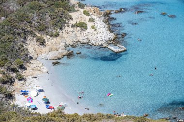 the beautiful Cala Porto Giunco beach in Villasimius with white sand and crystal clear water clipart