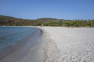 The beautiful white beach of Cala Pira in Castadias with its transparent and turquoise water clipart