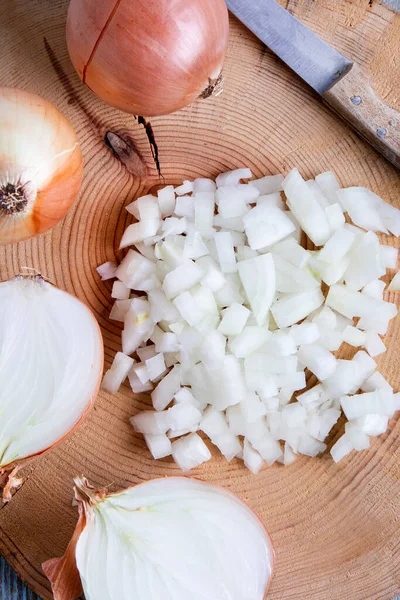 stock image onions cut in half and chopped on old wooden board