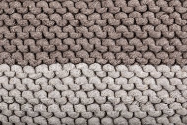 El yapımı örgü deseninin detayları (kahverenginin iki farklı tonu). Geçmişi. Doku.