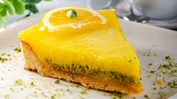 stock image Lemon cheese cake with sauce served on a white plate