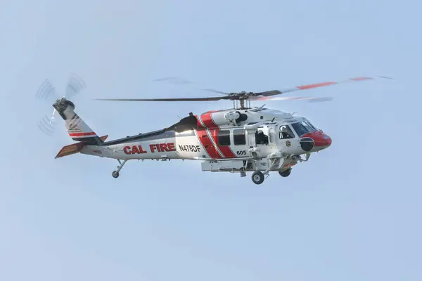 REDDDDING CALIFORNIA 10 AĞUSTOS 2024 Bir CALFIRE Sikorsky S70 Firehawk helikopteri Mary Lake üzerinde uçuyor..