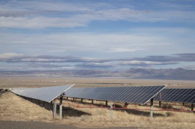 Photovoltaic panels serving as part of a larger solar farm in northwestern Nevada. clipart