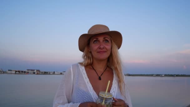 Beyaz Gömlekli Hasır Şapkalı Şirin Bir Kız Gün Batımında Deniz — Stok video