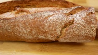 Baguette and pieces of chopped baguette on a wooden board. Panorama