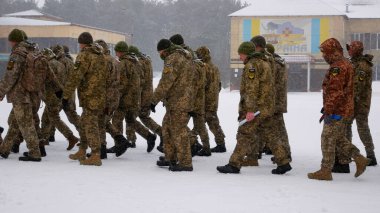 Kharkiv, Ukraine - January, 31, 2022: Ukrainian soldiers in military uniforms, with weapons, march in formation on the parade ground in winter. Russian-Ukrainian war 2022-2023. Ukrainian clipart