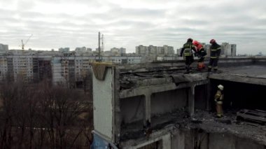 Kharkiv, Ukraine - January, 25, 2023: Rescuers walk on the roof of a multi-storey apartment building destroyed by a Russian missile strike in a Ukrainian city. Rescue operation during the Russian