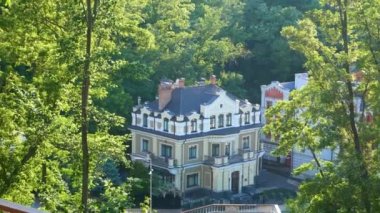 Beautiful old three-story house surrounded by green trees