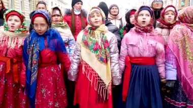 Kharkiv, Ukrayna - 13 Ocak 2022: Halk kostümlü çocuklar şehir merkezinde yürüyor ve bir sokak halk festivali sırasında şarkı söylüyorlar