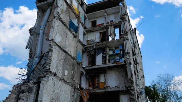 A residential multi-storey building destroyed by an air strike in a Ukrainian city. Russian-Ukrainian War 2022-2023. The house has no walls, the entrance is destroyed. Missile and air strikes of the