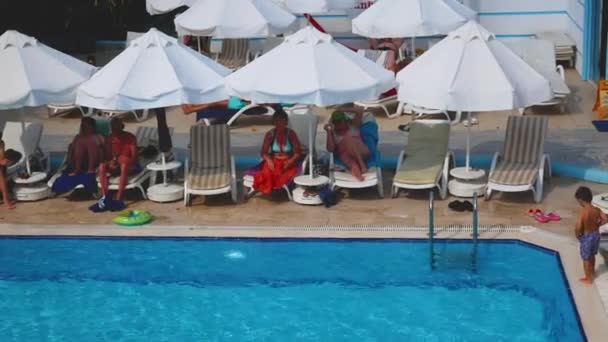 土耳其一侧 2023年6月18日 人们在酒店的游泳池边放松 一个小男孩沿着游泳池边走着 从上面看海滩暑假在炎炎夏日的游泳池边 放松一下 — 图库视频影像