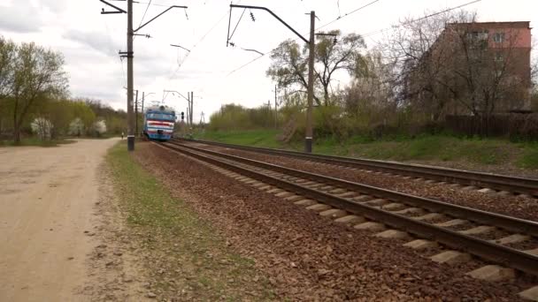 Electric Train Approaching Station Blue Carriages Slide Tracks Slow Background — Stock Video