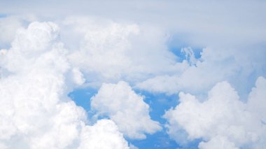 The camera floats over white clouds against a blue sky. View from above. Panorama. clipart