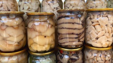 There are a lot of different canned mushrooms in jars. Homemade mushroom pickles. Harvesting mushrooms for the winter. Mushroom delicacies for the table. clipart