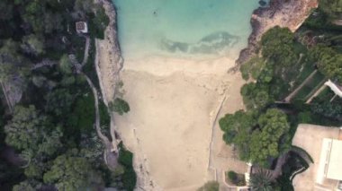 aerial recording of beautiful beach of mallorca, white sand, translucent turquoise sea, cala dor,mallorca, balearic islands spain, droone view