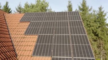 Evin çatısındaki güneş ışınlarından elektrik üretmek için fotovoltaik güneş panellerinden oluşan bir çiftlik. Yenilenebilir enerji kaynaklarından enerji tedariği için ekipman.