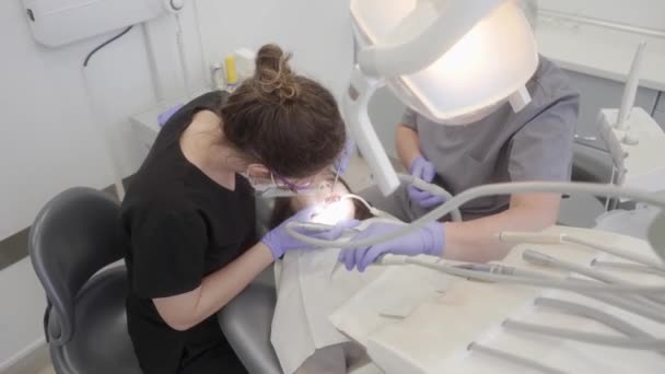 Θεραπεία Τερηδόνας Παιδί Στην Παιδιατρική Οδοντιατρική Οδοντίατρος Και Βοηθός Εκτελούν — Αρχείο Βίντεο