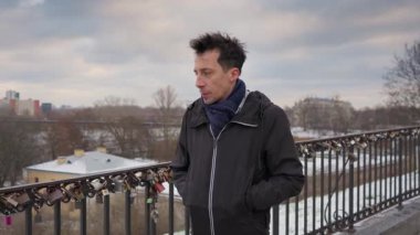 Melankolik bir ifadesi olan bir adam aşk köprüsünde tek başına duruyor. Düşüncelere dalmış, geçmiş anılarını yansıtıyor ya da aşk hayatının geleceğini hayal ediyor..