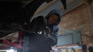 Garaj atölyesinde çalışan profesyonel bir tamirci bir arabanın bakımını yapar. Yetenekli adam aracın fren davulunu ve süspansiyonunu kontrol eder ve tamir eder..