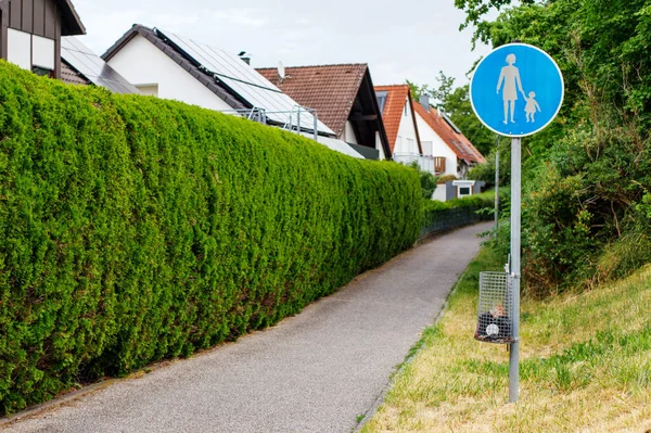 sign pedestrian area near the road and house